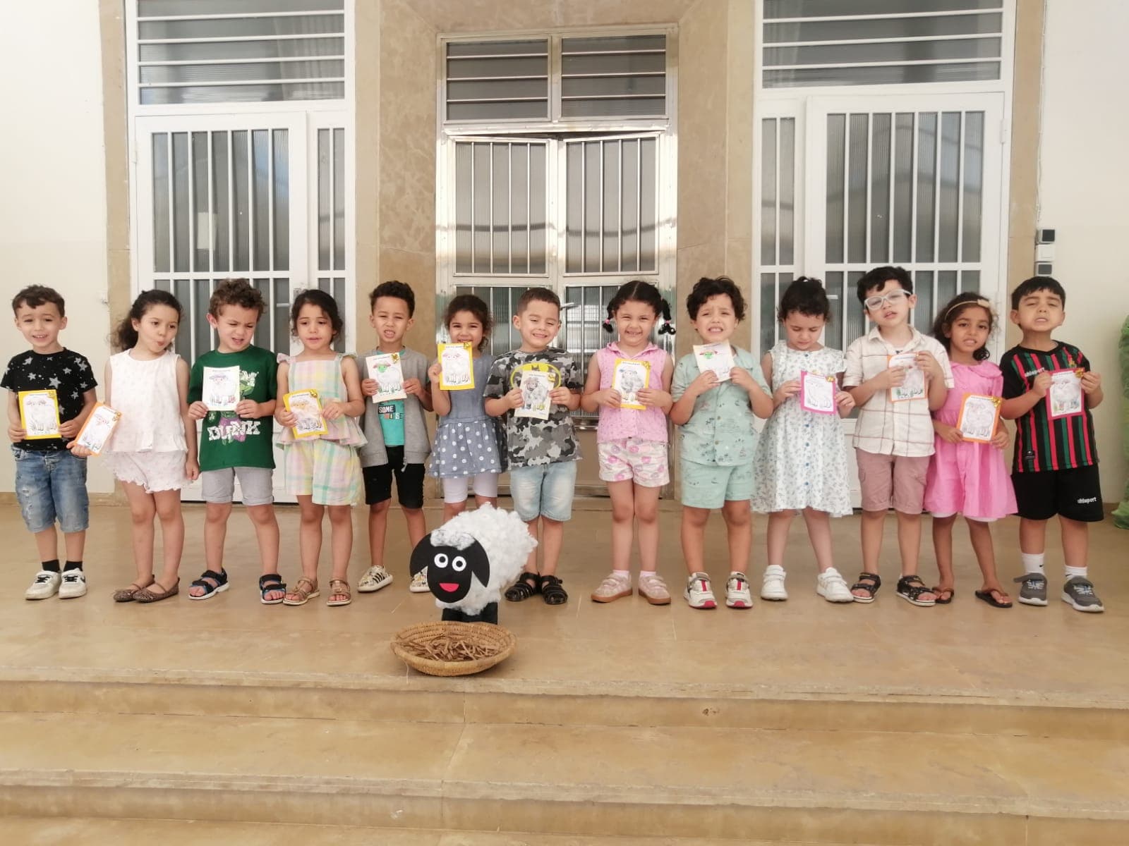 Élèves de maternelle fièrement présentant leurs créations